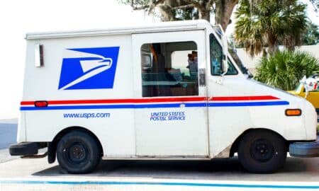 Usps Truck Delivering Mail On Suburban Street Parked In Occupied Space