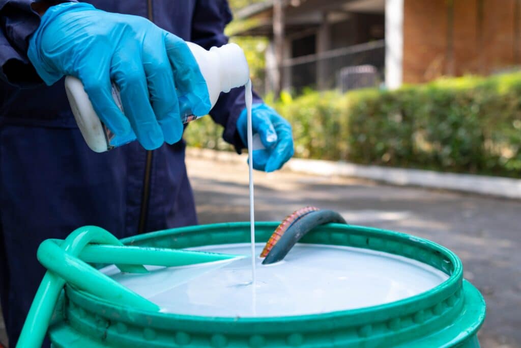 An Employee From Pest Control Company Is Spraying Chemicals To Kill The Insects.