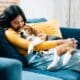 Adorable Beagle dog puppy sleeping on young female owner's shoulder.